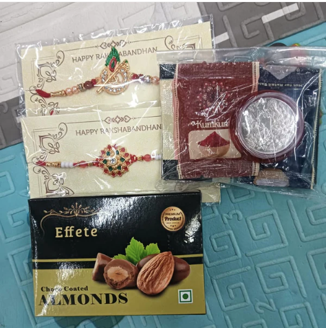 Rakhi Combo Gift Set – 2 Designer Rakhis with Silver Coin, Roli Chawal & Chocolate