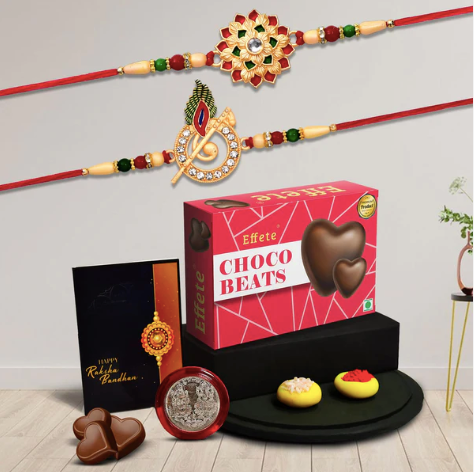 Designer Rakhi Combo Set – Krishna Flute & Floral Rakhis with Chocolates, Silver Coin & Greeting Card